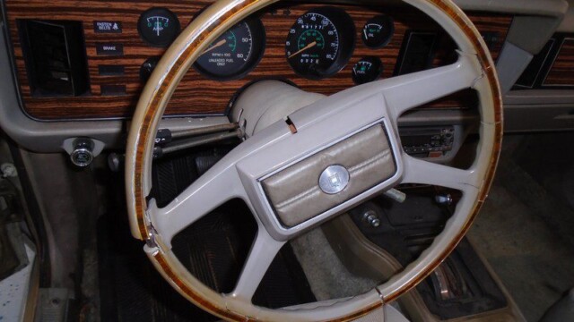 Classic car's broken wooden steering wheel.
