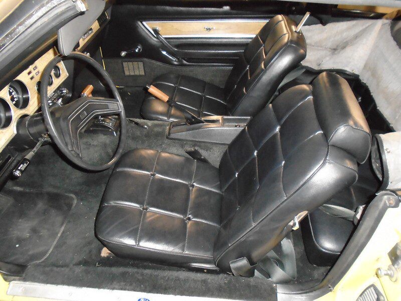 Yellow Ford Mustang interior, black leather seats.