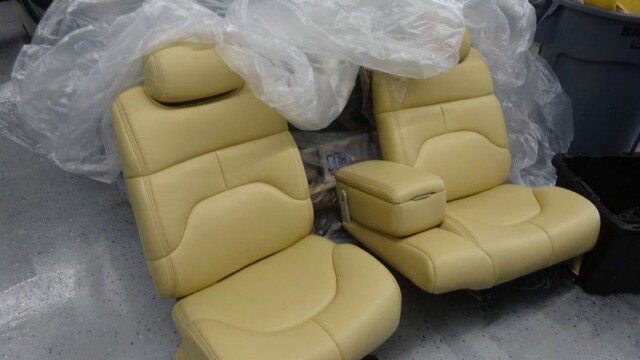Pair of tan leather car seats.