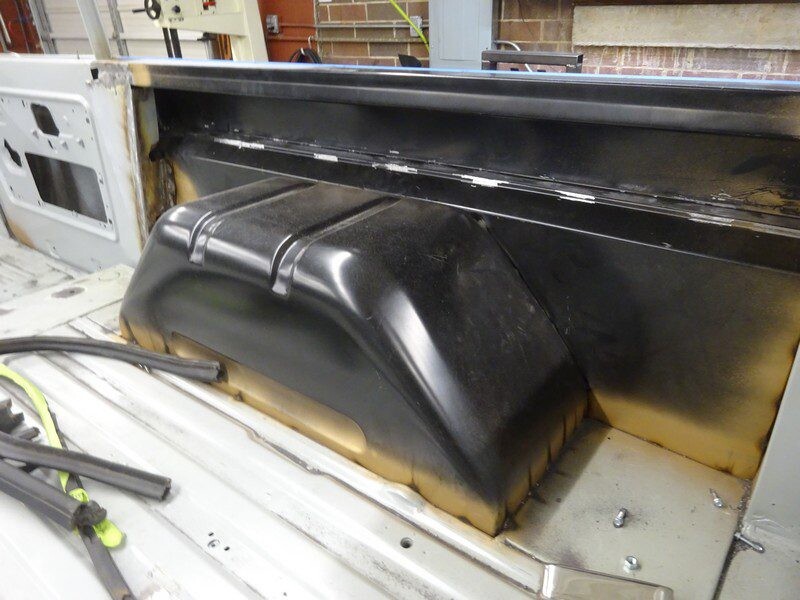 Here's an alt tag for the image: Truck bed restoration in progress.