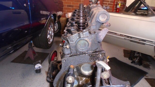 Car engine being repaired in garage.