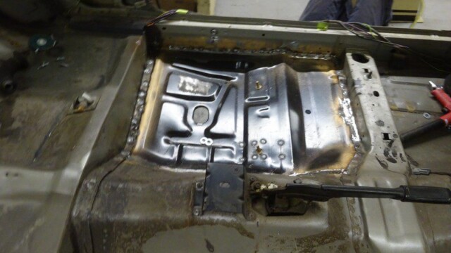 Passenger footwell with patched new metal panel