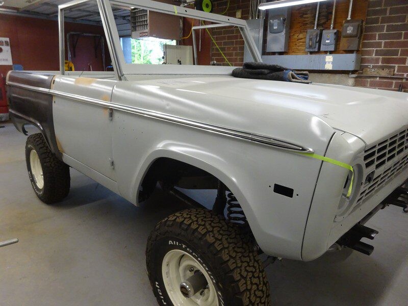 Primered Ford Bronco undergoing restoration.