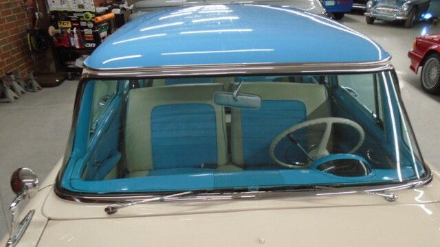 Vintage car, blue interior, cream exterior.