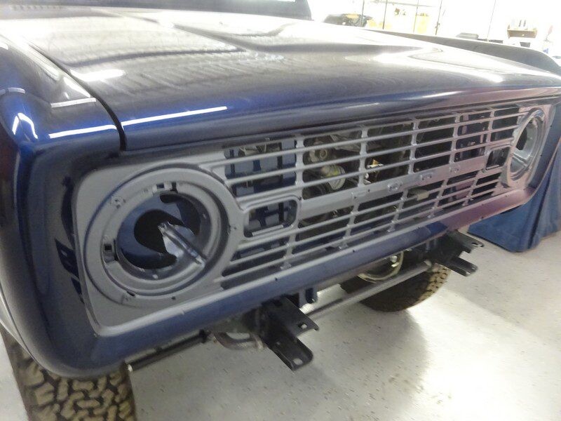 Here's an alt tag for the image: Blue Ford Bronco front grill detail.