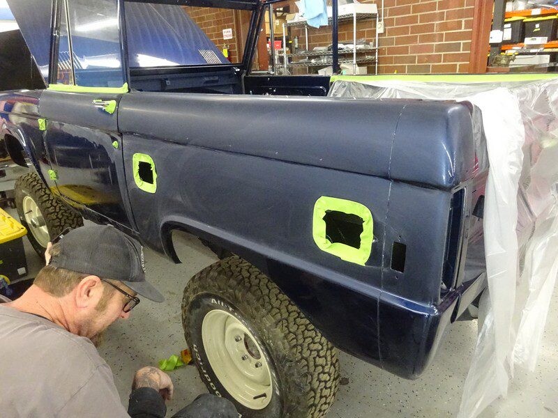 Mechanic repairing a vintage Bronco.