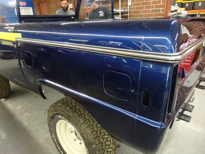 Here's an alt tag for the image: Dark blue Ford Bronco rear quarter panel.