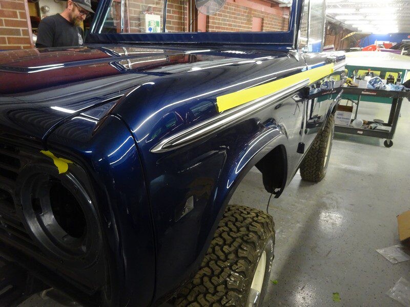 Dark blue Ford Bronco undergoing restoration.