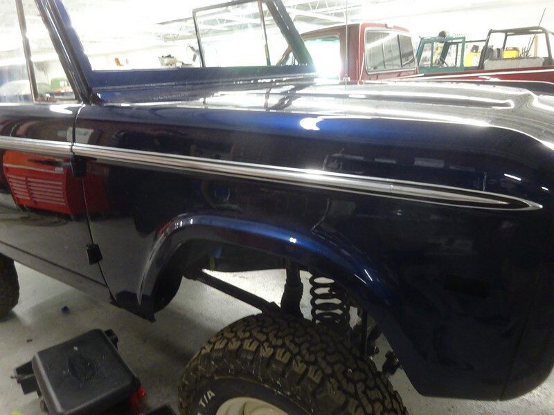 Restored classic Ford Bronco, dark blue.