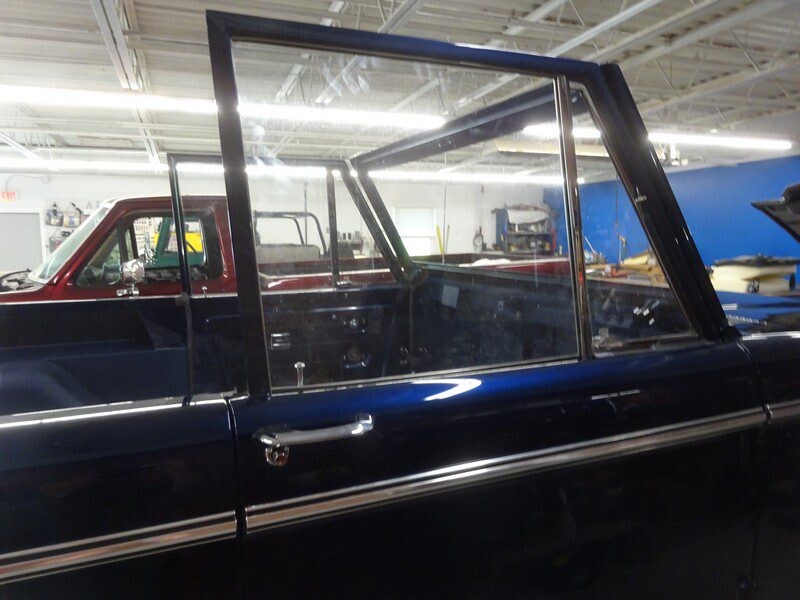 Here's an alt tag for the image: Dark blue Ford Bronco door detail.