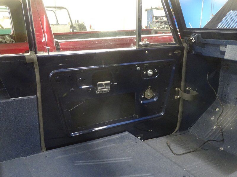 Here's an alt tag for the image: Dark blue Ford Bronco interior door.