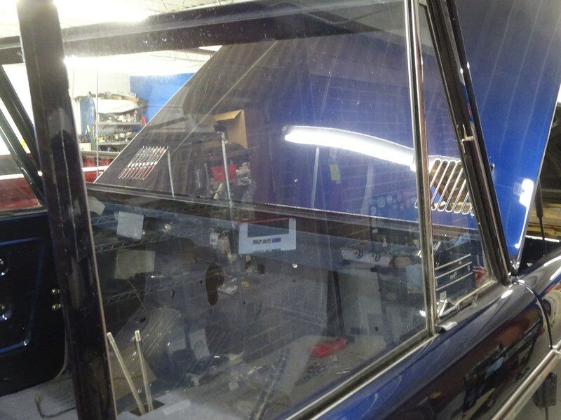 Here's an alt tag for the image: Blue classic car interior, under repair.