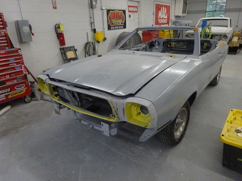 Gray primered Ford Mustang convertible.