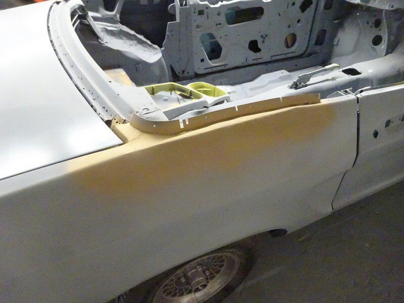 Quarter panel with body filler and primer