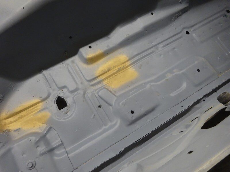 Gray car floor panel, primered.