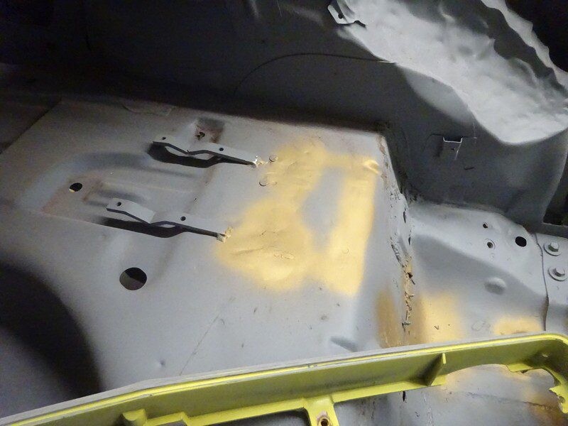 Car floor pan repair in progress.