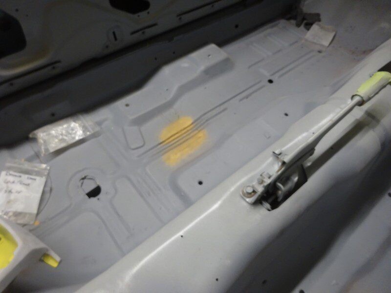 Interior floor pan primed, patched yellow areas