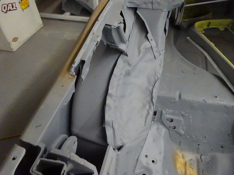 Close-up of primed wheelhouse seam repair