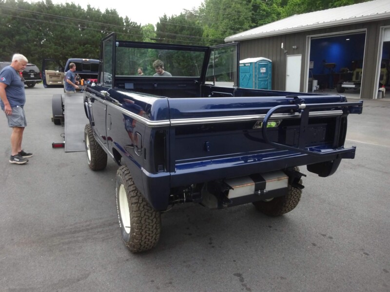 Here's an alt tag for the image: Rear view of a dark blue Ford Bronco.