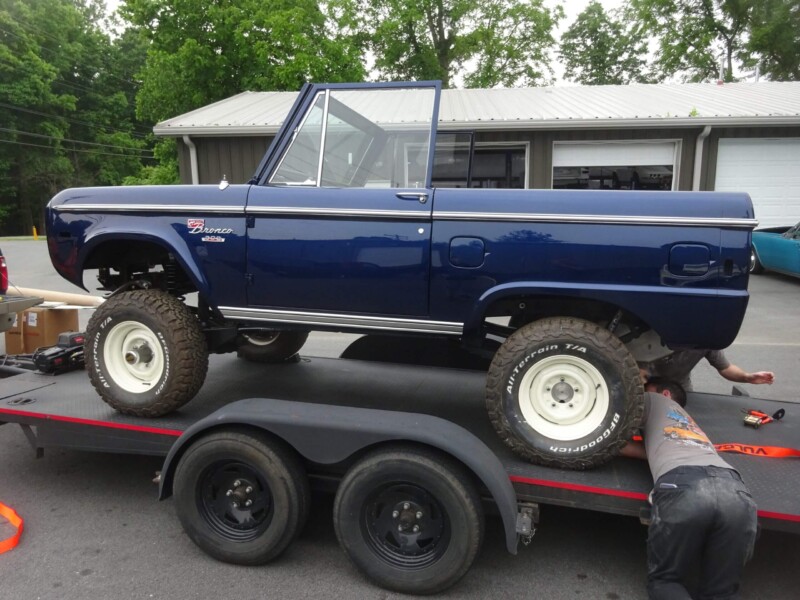 Blue Ford Bronco on trailer.