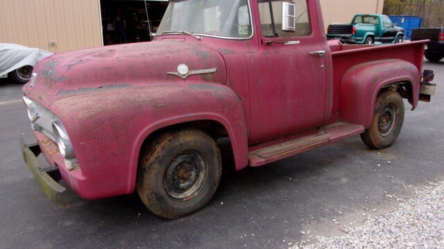 Rusty red vintage Ford pickup truck.