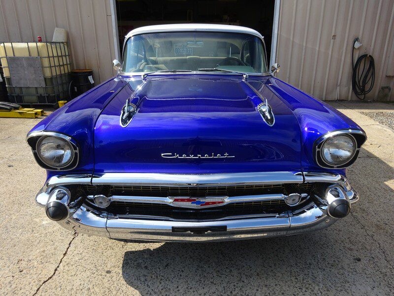 Here's an alt tag for the image: Blue 1957 Chevrolet Bel Air classic car.