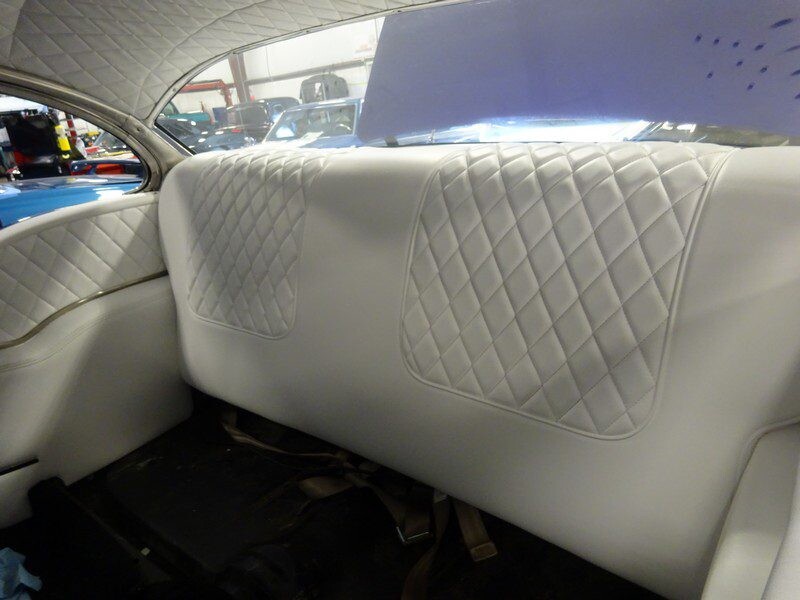 White diamond-tufted car back seat.