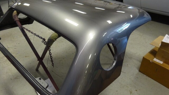 Gray car hardtop in progress.