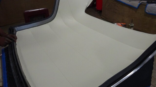 Off-white car interior panel installation.