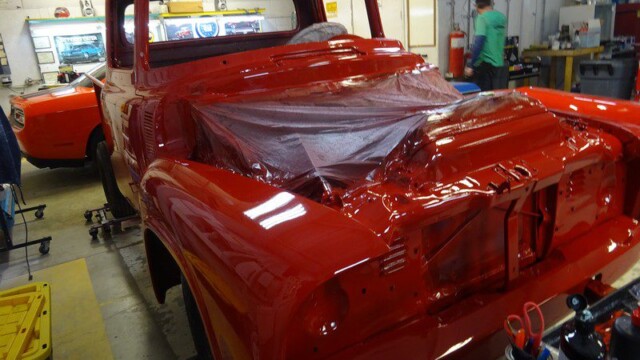 Red classic truck undergoing restoration.
