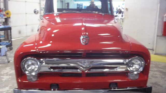 Restored red Ford F-100 pickup truck.