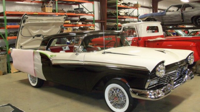Here's an 8-word alt tag for the image: Classic black and white Ford Fairlane in garage.