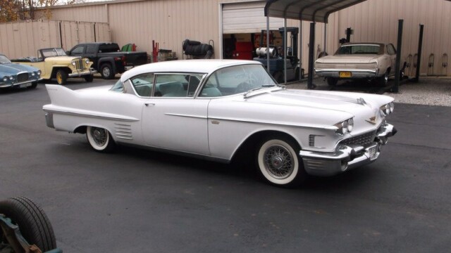 White Cadillac Eldorado in garage.