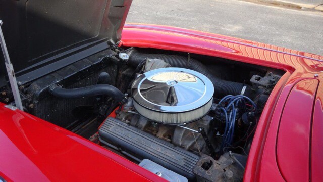Red classic car engine detail.