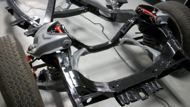 Black classic car chassis restoration.