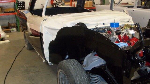 Black classic car under restoration.