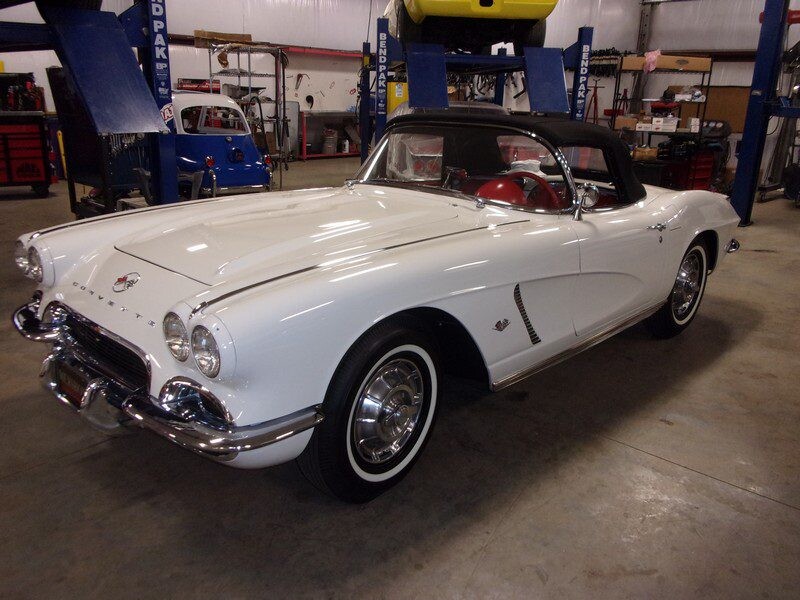 White 1960 Corvette convertible in garage.