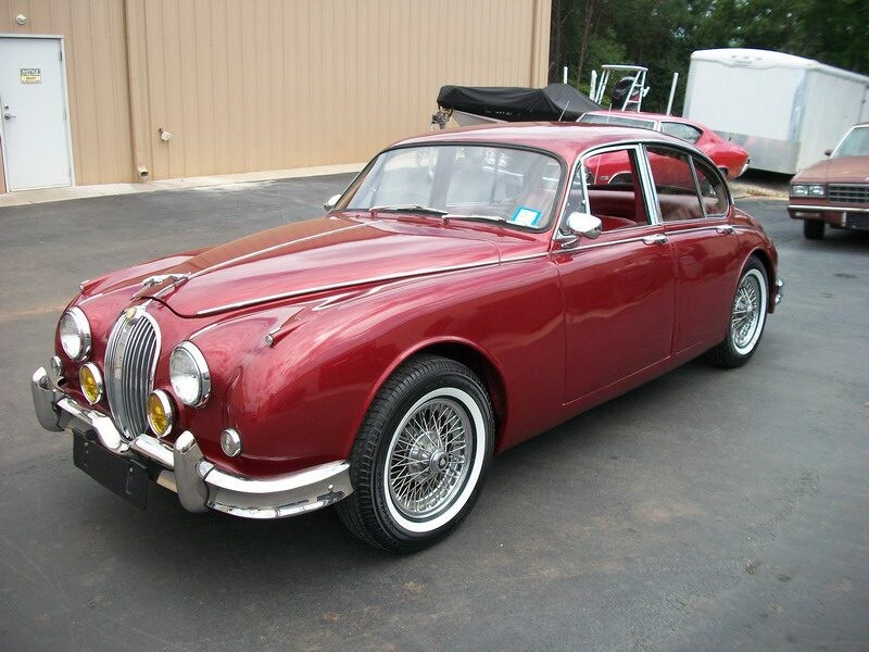Red classic Jaguar Mark II sedan.