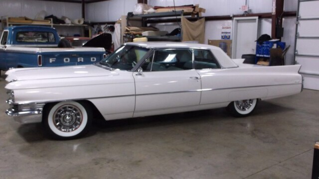 White Cadillac Coupe in garage.