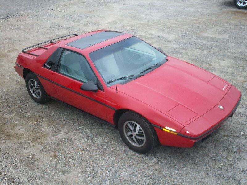 Red Pontiac Fiero sports coupe.