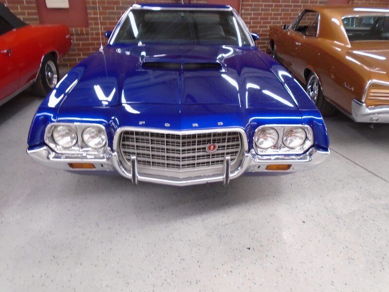 Blue Ford Torino muscle car front view.