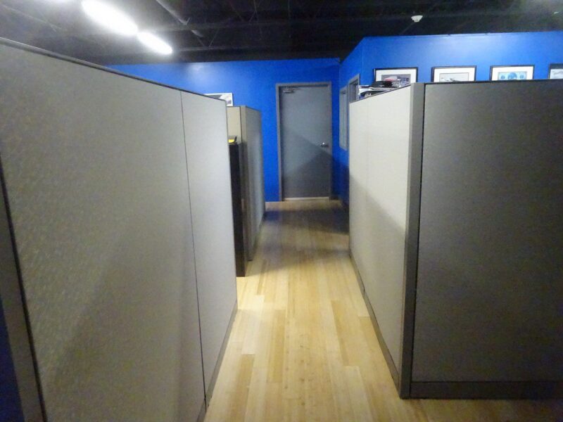 Office hallway with cubicle walls.