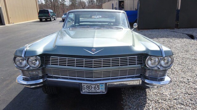 Vintage green Cadillac front view.