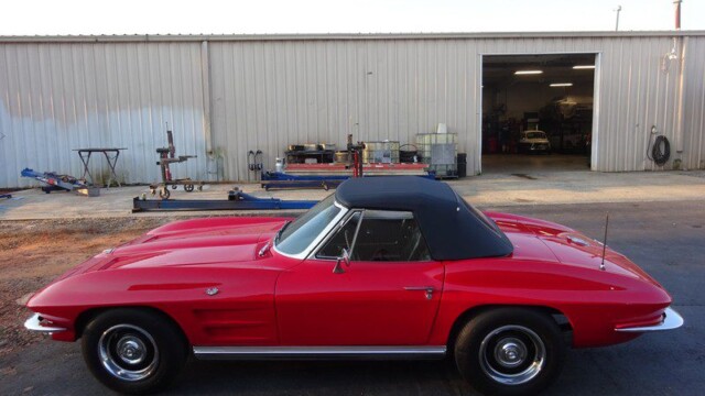 Red Corvette convertible side profile with black top