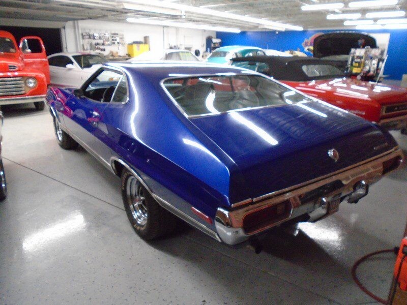 Rear three-quarter view of blue Torino