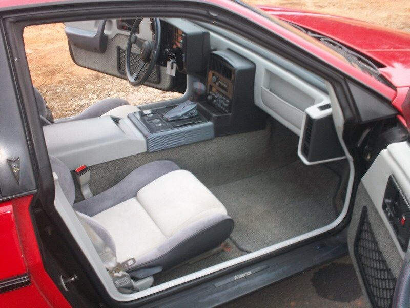 Red Pontiac Fiero interior, driver's side.
