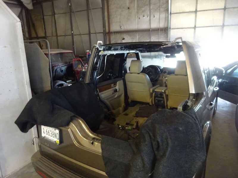 Land Rover undergoing repair in garage.