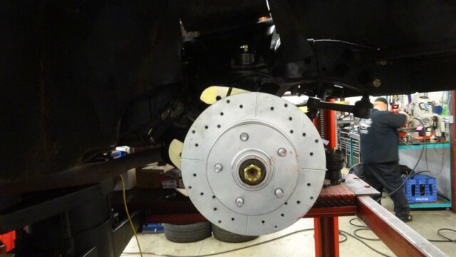 Car brake rotor installation in progress.