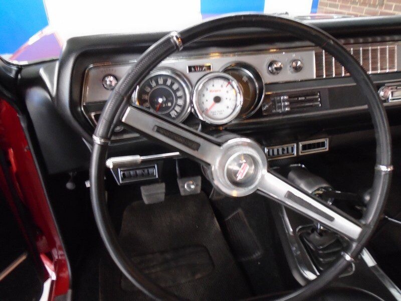Classic car interior dashboard and steering wheel.