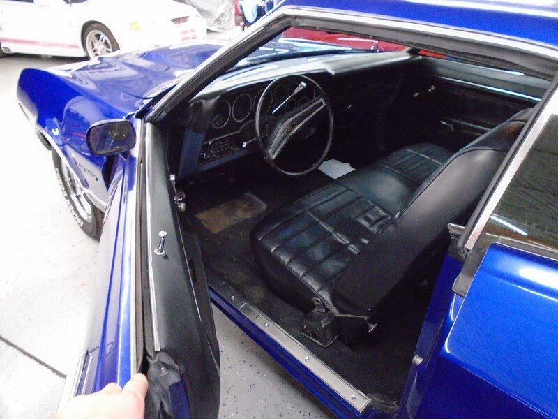 Blue Ford Torino interior, open door.